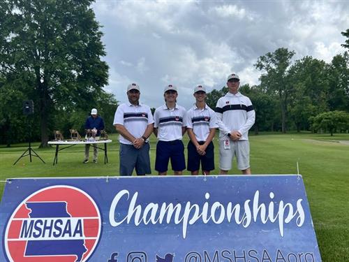 Liberty Athletes and Coaches in group photo behind MSHSAA Championship sign